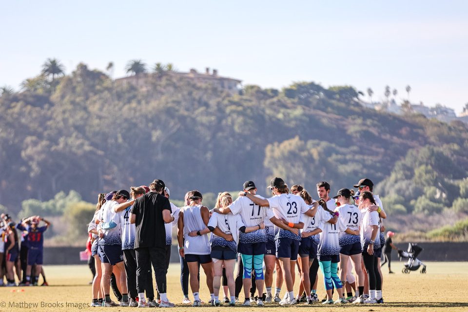 A team huddle at an Ultimate Frisbee tournament