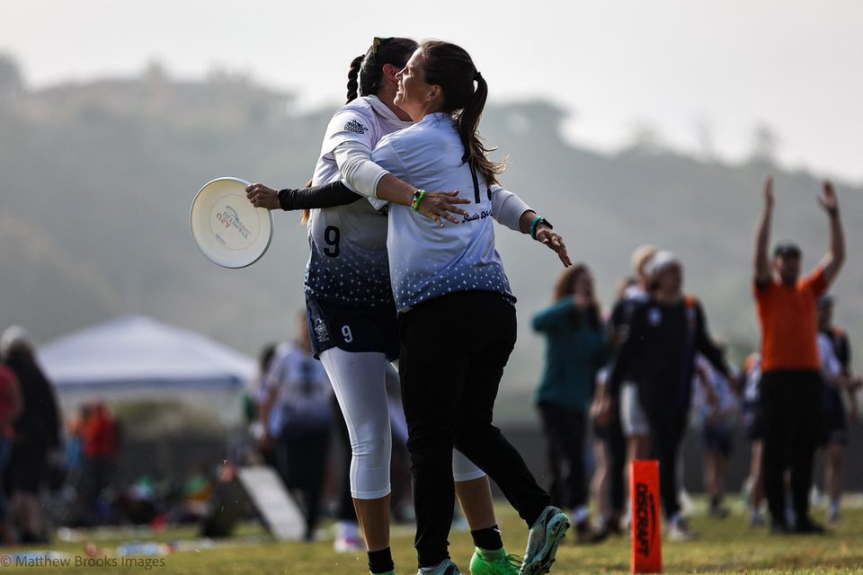 Teammates celebrating with a hug on the field